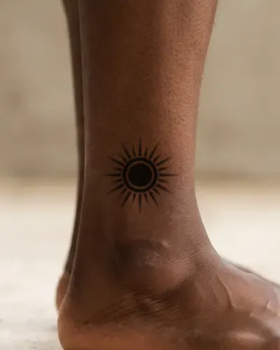 Blackwork sun tattoo on a ankle, preview