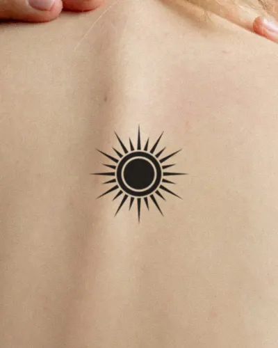 Blackwork sun tattoo on a back, preview
