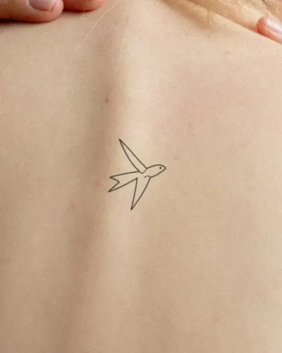 Fine line swallow tattoo on a back, preview
