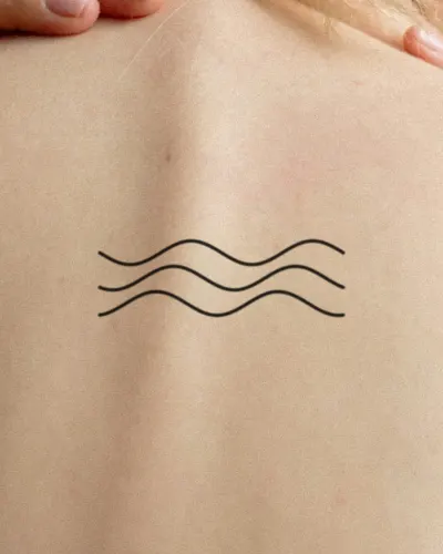 Ocean waves tattoo on a back, preview
