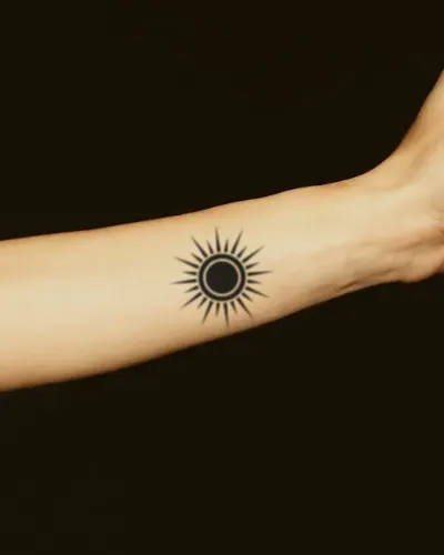 Blackwork sun tattoo on a forearm, preview