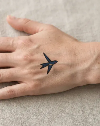 Traditional swallow tattoo on a hand, preview