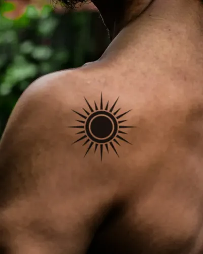 Blackwork sun tattoo on a shoulder, preview