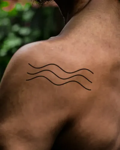 Ocean waves tattoo on a shoulder, preview