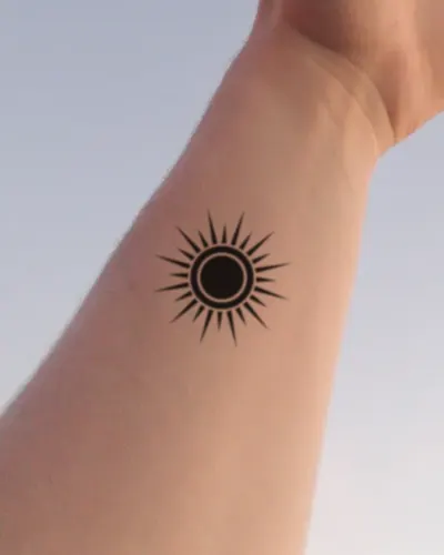 Blackwork sun tattoo on a wrist, preview