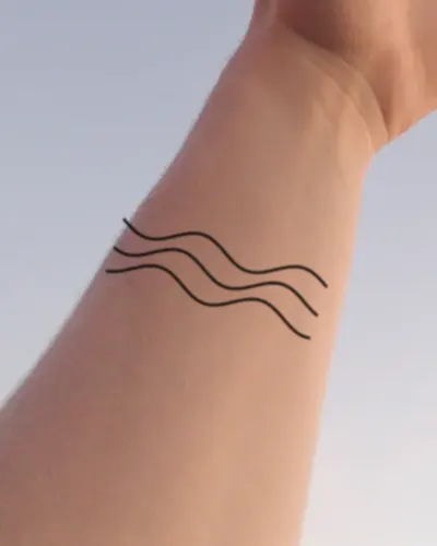 Ocean waves tattoo on a wrist, preview